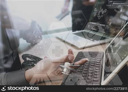 medical doctor hand working with smart phone,digital tablet computer,stethoscope eyeglass,on wooden desk,virtual graphic interface icons screen
