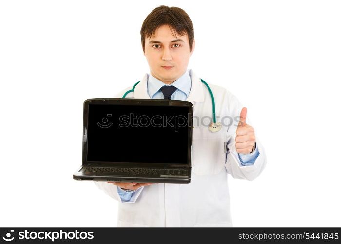 Medical doctor holding laptops with blank screen and showing thumbs up gesture isolated on white&#xA;