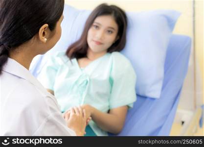 medical doctor holding patient's hands to cheer up patient