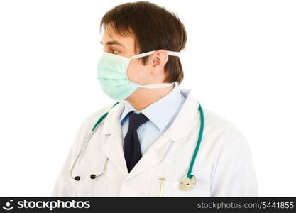 Medical doctor in mask looking at copy space isolated on white&#xA;