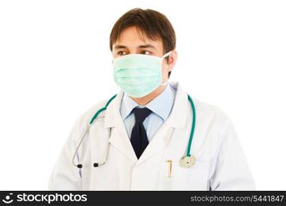 Medical doctor in mask looking in corner at copy space isolated on white&#xA;