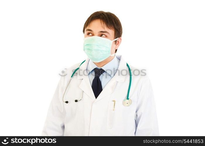 Medical doctor in mask looking up at copy space isolated on white&#xA;