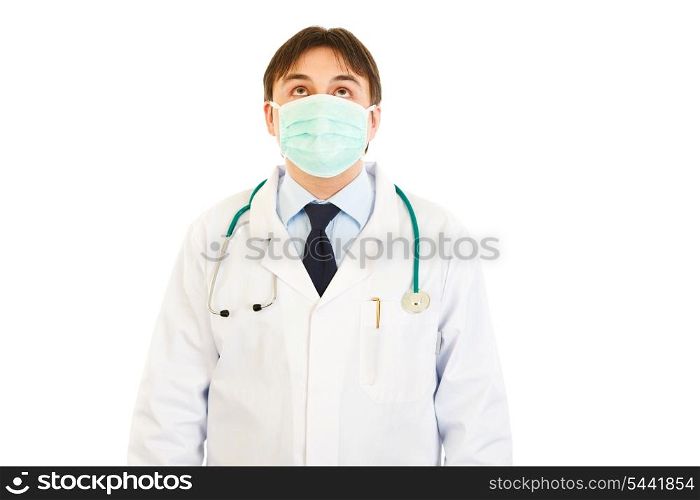 Medical doctor in mask looking up isolated on white&#xA;