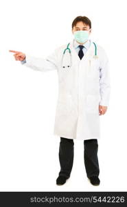 Medical doctor in mask pointing finger at something isolated on white&#xA;