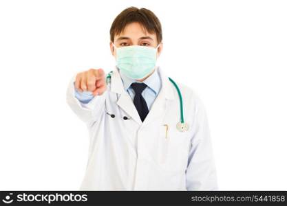 Medical doctor in mask pointing finger at you isolated on white&#xA;