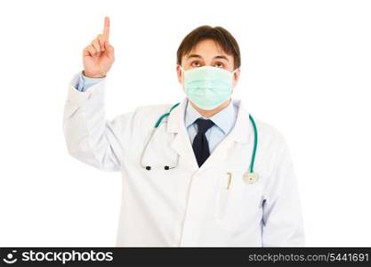 Medical doctor in mask pointing finger up isolated on white&#xA;