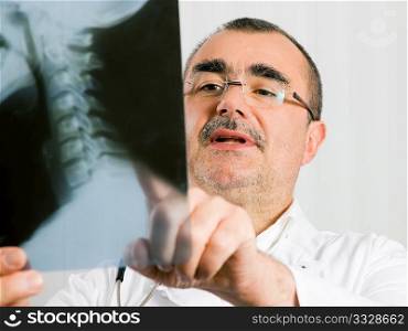Medical Doctor looking at a x-ray picture of a spine