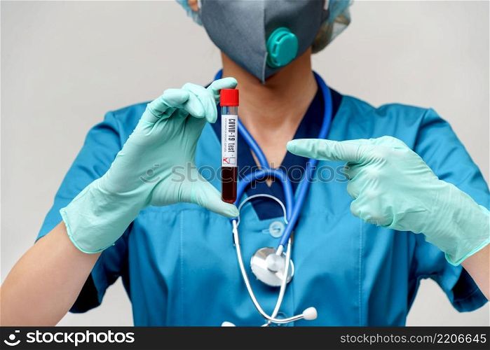 medical doctor nurse woman wearing protective mask and gloves - holding negative coronavirus COVID-19 blood test.. medical doctor nurse woman wearing protective mask and gloves - holding negative coronavirus COVID-19 blood test
