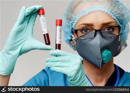 medical doctor nurse woman wearing protective mask and gloves - holding negative and positive coronavirus COVID-19 blood test.. medical doctor nurse woman wearing protective mask and gloves - holding negative and positive coronavirus COVID-19 blood test