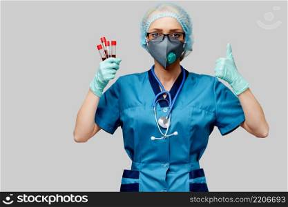 medical doctor nurse woman wearing protective mask and gloves - holding virus blood test tube.. medical doctor nurse woman wearing protective mask and gloves - holding virus blood test tube