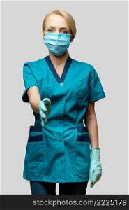 medical doctor nurse woman wearing protective mask and latex gloves - ready for handshake gesture.. medical doctor nurse woman wearing protective mask and latex gloves - ready for handshake gesture