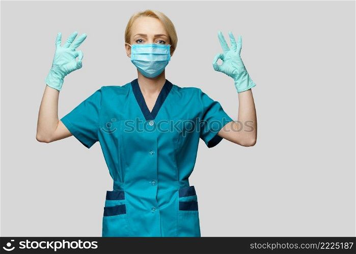 medical doctor nurse woman wearing protective mask and latex gloves - showing OK sign.. medical doctor nurse woman wearing protective mask and latex gloves - showing OK sign