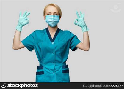 medical doctor nurse woman wearing protective mask and latex gloves - showing OK sign.. medical doctor nurse woman wearing protective mask and latex gloves - showing OK sign