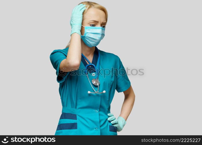 medical doctor nurse woman wearing protective mask and rubber or latex gloves - headache and stress.. medical doctor nurse woman wearing protective mask and rubber or latex gloves - headache and stress