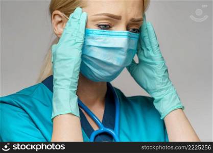 medical doctor nurse woman wearing protective mask and rubber or latex gloves - headache and stress.. medical doctor nurse woman wearing protective mask and rubber or latex gloves - headache and stress