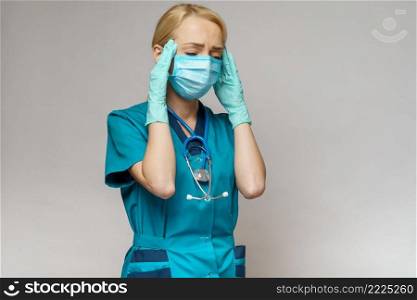 medical doctor nurse woman wearing protective mask and rubber or latex gloves - headache and stress.. medical doctor nurse woman wearing protective mask and rubber or latex gloves - headache and stress