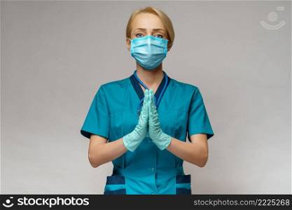 medical doctor nurse woman wearing protective mask and rubber or latex gloves - holding pills.. medical doctor nurse woman wearing protective mask and latex gloves - praying nad hoping gesture