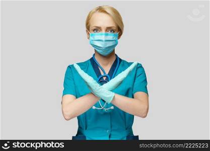 medical doctor nurse woman wearing protective mask and rubber or latex gloves - stop sign gesture.. medical doctor nurse woman wearing protective mask and rubber or latex gloves - stop sign gesture
