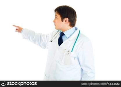 Medical doctor pointing finger in corner at copy space isolated on white&#xA;