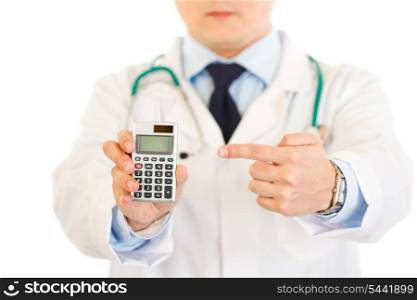 Medical doctor pointing finger on calculator isolated on white. Close-up.&#xA;