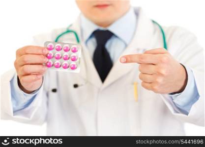 Medical doctor pointing finger on pack of pills isolated on white. Close-up.&#xA;