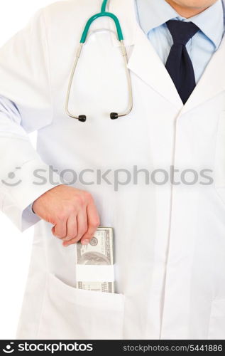 Medical doctor putting money in pocket robe isolated on white. Close-up.&#xA;