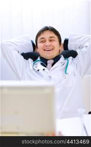 Medical doctor sitting at office table and relaxing&#xA;