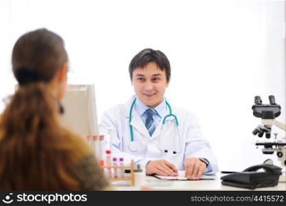 Medical doctor speaking with patient at office