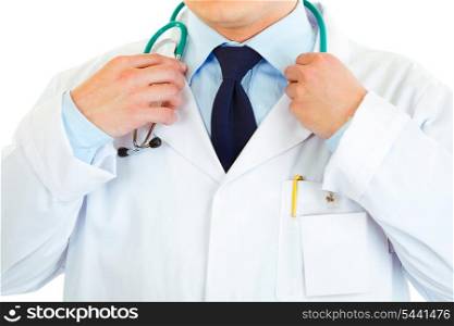 Medical doctor straightening stethoscope isolated on white. Close-up.&#xA;