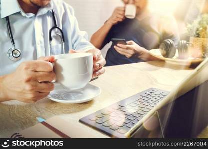 Medical doctor team taking coffee break.using digital tab≤t docking smart keyboard and smart pho≠on marb≤desk.listenμsic,fi<er film effect