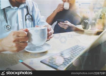 Medical doctor team taking coffee break.using digital tablet docking smart keyboard and smart phone on marble desk.listen music,filter film effect