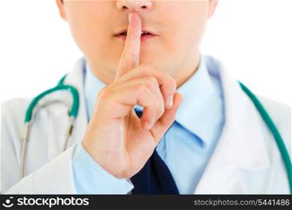 Medical doctor with finger at mouth isolated on white. Shh gesture&#xA;