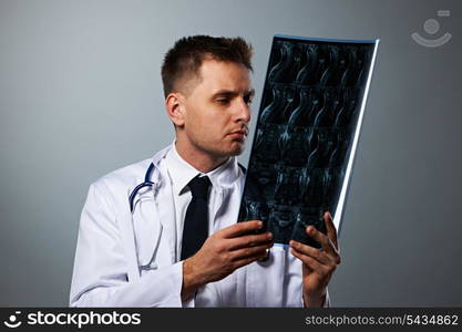 Medical doctor with MRI spinal scan portrait against grey background