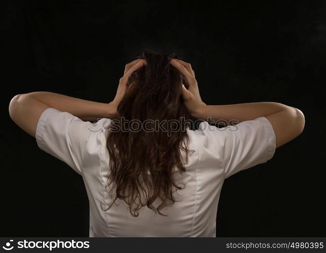 Medical doctor woman holding her head. Headache. Rear view