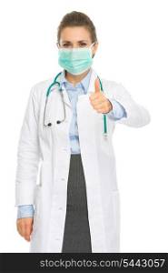 Medical doctor woman in mask showing thumbs up
