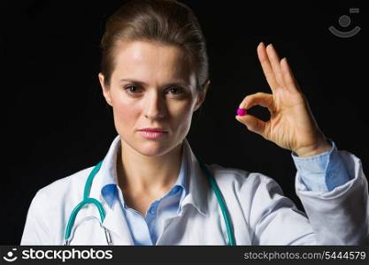 Medical doctor woman showing tablets isolated on black