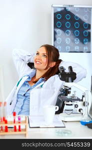 Medical doctor woman sitting at office table and relaxing&#xA;