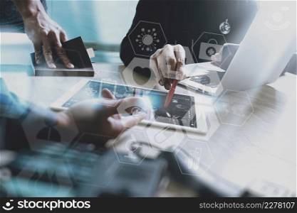 medical doctor working with smart phone and digital tablet computer with stethoscope and eyeglass on marble desk with virtual graphic interface icons screen as concept