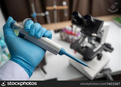 Medical equipment Blood test. Pipette adding fluid to one of several test tubes
