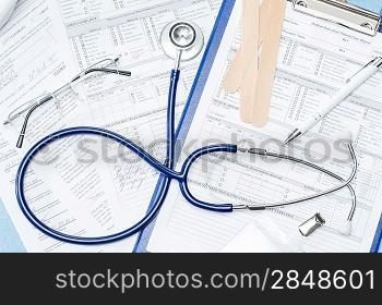 Medical equipment on doctor&acute;s office desk stethoscope patient documents