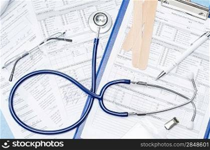 Medical equipment on doctor&acute;s office desk stethoscope patient documents