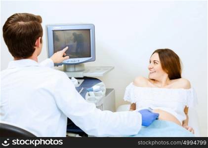 Medical examination. Young pregnant woman examined by doctor at ultrasound check