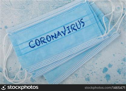 Medical face mask with coronavirus written on it on blue. Best protection from coronavirus, germs,bacteria and viruses. For hospital and every day use.