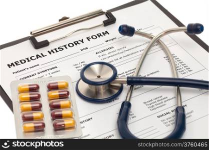 Medical history form with pills and stethoscope