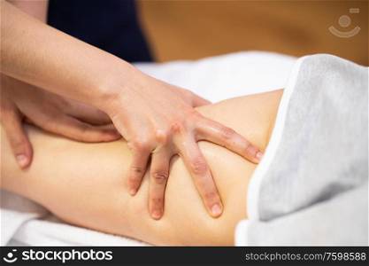 Medical massage at the leg in a physiotherapy center. Female physiotherapist inspecting her patient.. Medical massage at the leg in a physiotherapy center.