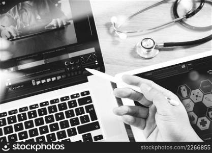 Medical network technology concept. Doctor hand working with stethoscope and laptop computer digital tablet with medical chart interface. View from top and close up photo. Double exposure effects, black white