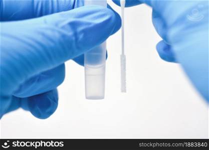 Medical personnel compare a cotton swab and saline extraction tube for diagnostic covid-19,Coronavirus infectious protective concept