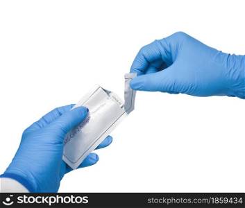 Medical personnel hand tearing envelope of Covid-19 antigen rapid test kit on white background,Coronavirus infectious protect concept