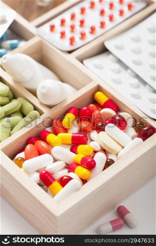 medical pills and ampules in wooden box