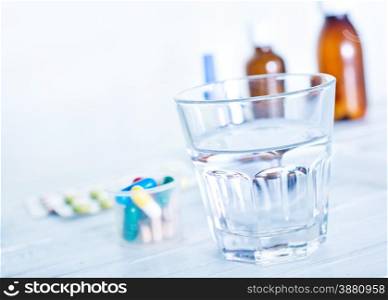 medical pills and water on the table